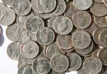 A pile of American coins as Fanatics plans to add a transaction fee to online wagers in Illinois.