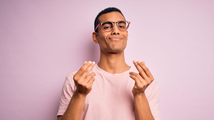 A man doing the hand gesture representing money, richness or payment