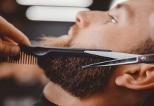 A man's beard being trimmed