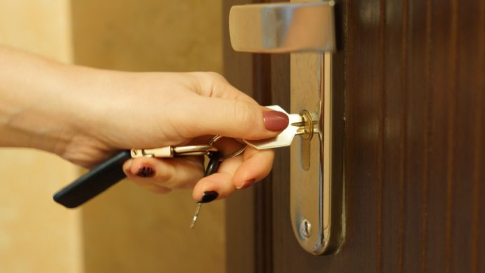 A person puts a key into a door as Kambi and LeoVegas extend their turnkey solutions deal.