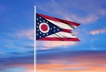The flag of Ohio against a colourful sky