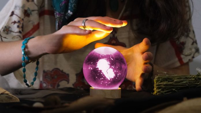 A fortune-teller predicting the future using a crystal ball