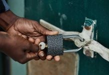 Hands locking a lock