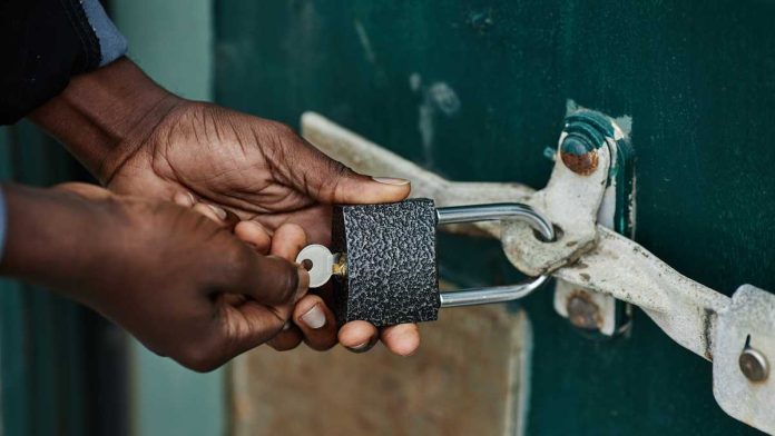 Hands locking a lock