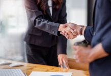 Two people shaking hands on a business deal
