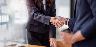 Two people shaking hands on a business deal