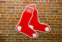 The Boston Red Sox logo on a brick wall
