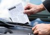 Tennessee fines 5 offshore sportsbooks in quest to ‘eliminate’ bad actors A person putting a violation notice on a car windshield