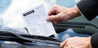 Tennessee fines 5 offshore sportsbooks in quest to ‘eliminate’ bad actors A person putting a violation notice on a car windshield