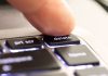 A person hitting a 'delete' button
