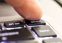 A person hitting a 'delete' button