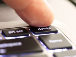 A person hitting a 'delete' button