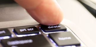 A person hitting a 'delete' button
