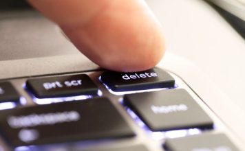 A person hitting a 'delete' button