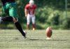 A player kicks a football as the owner of VGW deals with backlash due to a casino brand.