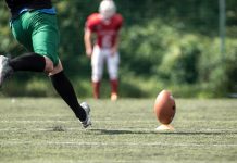 A player kicks a football as the owner of VGW deals with backlash due to a casino brand.