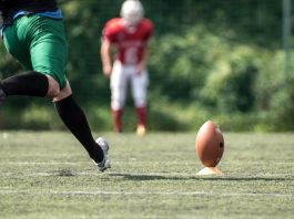 A player kicks a football as the owner of VGW deals with backlash due to a casino brand.
