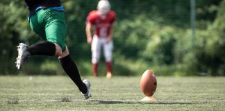A player kicks a football as the owner of VGW deals with backlash due to a casino brand.