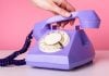 Hand picking up rotary phone