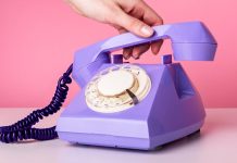 Hand picking up rotary phone