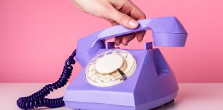 Major gaming trade groups call for resolution to protect 1-800-GAMBLER Hand picking up rotary phone