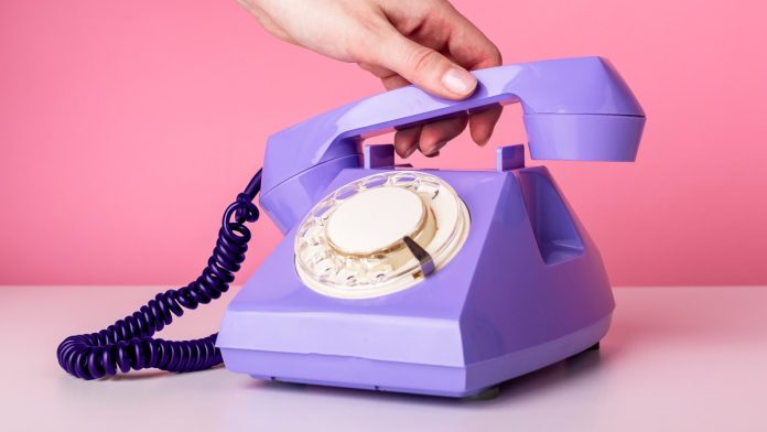 AGA-ROGA-1-800-GAMBLER Hand picking up rotary phone