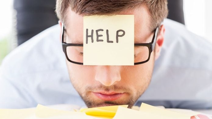 AGs'-cry-for-help-to-DOJ-again-shows-states-need-backup-to-fight-illegal-gambling A man when a sticky note on his forehead asking for help
