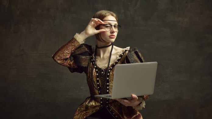 An aristocratic-looking woman holds a laptop