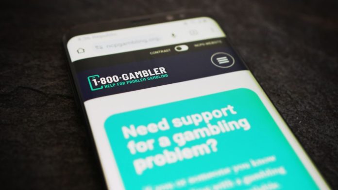 An information page for the 1-800-GAMBLER problem gambling hotline on a cellphone