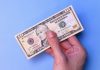 Circa Sports implements $10 minimum bet in Illinois after tax change A person's hand holding an American $10 bill