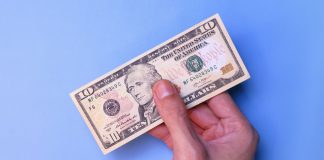 Circa Sports implements $10 minimum bet in Illinois after tax change A person's hand holding an American $10 bill