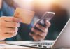 A person holds a credit card as DraftKings plans to ban credit card deposits.
