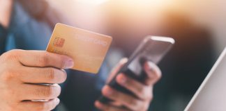 A person holds a credit card as DraftKings plans to ban credit card deposits.