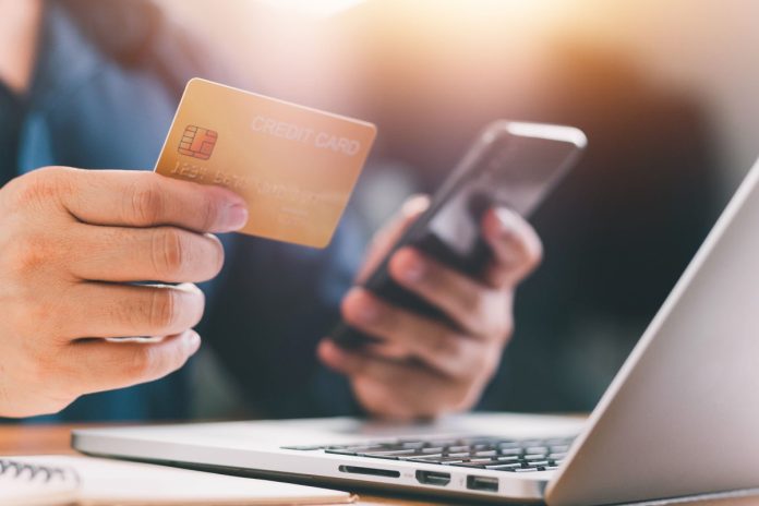 DraftKings-Credit-Card-No-Longer-Accepted A person holds a credit card as DraftKings plans to ban credit card deposits.