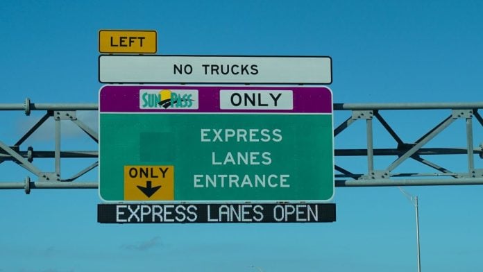 A sign for an exit to the express lane on a highway in Miami