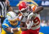 Kansas City Chiefs running back Kareem Hunt runs past LA Chargers linebacker Daiyan Henley during an NFL game