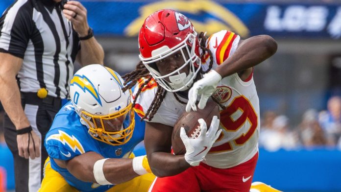 Kansas City Chiefs running back Kareem Hunt runs past LA Chargers linebacker Daiyan Henley during an NFL game