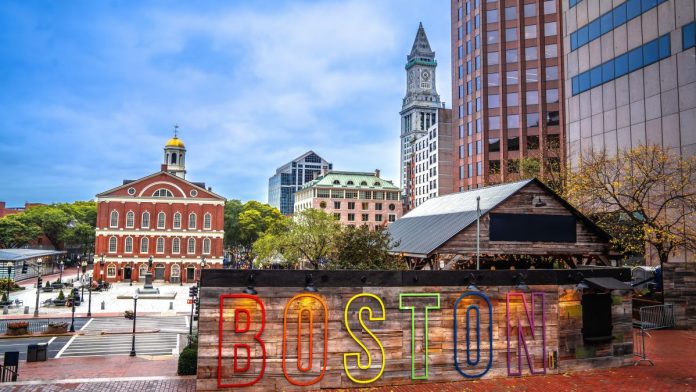 Massachusetts-rep.-files-bill-to-ban-sweeps-as-part-of--iGaming-legalization A Boston sign with Boston architecture in the background