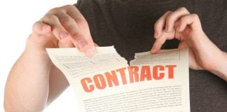 A person rips up a contract