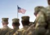 Senators pushing for funding for military gambling addiction research U.S. army personnel facing a flying American flag