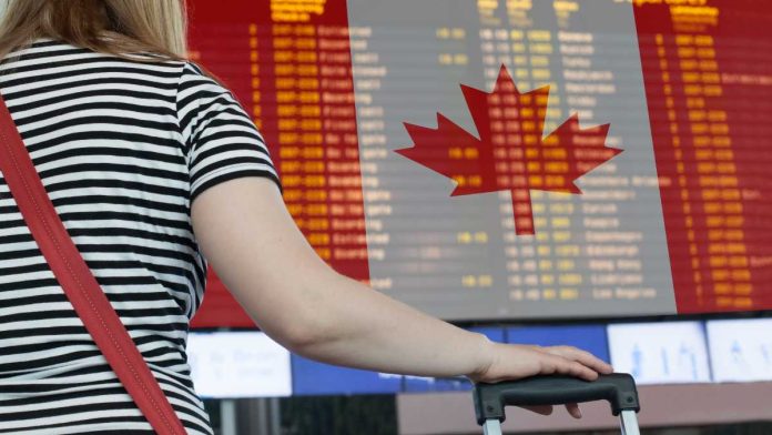 VGW-Global-Chumba-Canada-Exit Woman looking at departures board at airport sporting Canadian flag