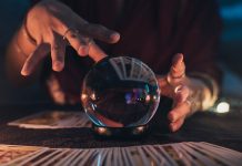 A fortune-teller using a crystal ball to predict the future