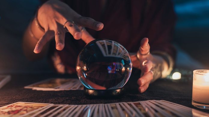 A fortune-teller using a crystal ball to predict the future