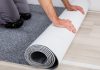 Caesars Sportsbook rolls out NFL live betting upgrades with Kero Sports A person rolling out new carpet onto a hard wood floor