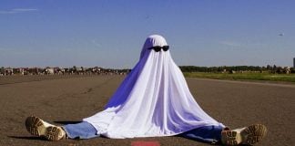 DraftKings looks to fuel further parlay growth with NFL Ghost Leg payout A person dressed as a ghost wearing sunglasses and sat with their legs spread
