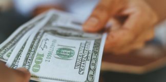 Illinois sportsbooks paid $5.2M in wager tax in first month of new fee A person handing over money, as if to the taxman