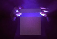 Hands opening a glowing box