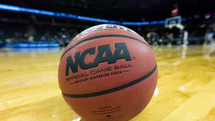 NCAA basketball as the organization bans three players.