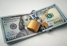 A stack of 100 dollar bills padlocked