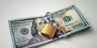 A stack of 100 dollar bills padlocked